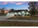 One-story house with attached garage, landscaping, and a teal accent at 4438 Crescent Rd, Spring Hill, FL 34606