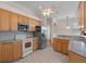 Kitchen with wood cabinets and stainless steel appliances at 4438 Crescent Rd, Spring Hill, FL 34606