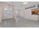 Open living room with tile floors and kitchen access at 4438 Crescent Rd, Spring Hill, FL 34606