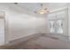 Main bedroom with carpet, French doors, and a ceiling fan at 4438 Crescent Rd, Spring Hill, FL 34606