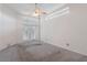 Main bedroom with carpet, French doors, and a ceiling fan at 4438 Crescent Rd, Spring Hill, FL 34606