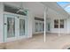 Spacious covered patio with French doors and ceiling fans at 4438 Crescent Rd, Spring Hill, FL 34606