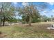 Serene pond view with lush trees and grass at 4438 Crescent Rd, Spring Hill, FL 34606