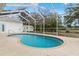 Relaxing kidney-shaped pool with screened enclosure at 4438 Crescent Rd, Spring Hill, FL 34606