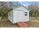 White shed with ramp access in backyard at 4438 Crescent Rd, Spring Hill, FL 34606