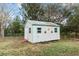 White shed with green trim in backyard at 4438 Crescent Rd, Spring Hill, FL 34606