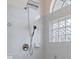 Bathroom shower with dual shower heads and glass block window at 4438 Crescent Rd, Spring Hill, FL 34606
