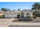 Charming single-story home featuring a well-manicured lawn and a brick driveway at 444 Quane Ave, Spring Hill, FL 34609