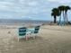 Peaceful beachfront view with two chairs and small table at 4555 Marine Pkwy # 103, New Port Richey, FL 34652