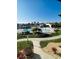 Community pool with lounge chairs and tropical landscaping at 4555 Marine Pkwy # 103, New Port Richey, FL 34652