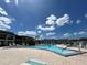 Community swimming pool with lounge chairs at 4555 Marine Pkwy # 103, New Port Richey, FL 34652