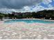 Community pool with spacious deck and surrounding apartment buildings at 4555 Marine Pkwy # 103, New Port Richey, FL 34652