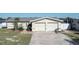 Front view of a single-story house with a two-car garage at 4949 Waterside Dr, Port Richey, FL 34668