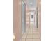 Long hallway with light walls and tile floors at 5021 Secretariat Run, Spring Hill, FL 34609