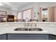 Kitchen island with double sink, quartz countertops, and breakfast bar at 5021 Secretariat Run, Spring Hill, FL 34609