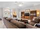 Comfortable living room featuring a sectional sofa and built-in shelving at 5021 Secretariat Run, Spring Hill, FL 34609