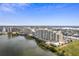 Aerial view of waterfront condo building with parking and surrounding cityscape at 5915 Sea Ranch Dr # 111, Hudson, FL 34667