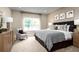 Spacious bedroom with king-size bed and sitting area at 6027 Wild Petunia Dr, Wimauma, FL 33598