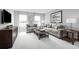 Spacious bonus room with gray sofas, a coffee table, and ample natural light at 6033 Wild Petunia Dr, Wimauma, FL 33598