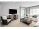 Gathering room with a neutral color palette, comfy seating, and a sliding glass door at 6033 Wild Petunia Dr, Wimauma, FL 33598