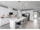 White kitchen with stainless steel appliances and a large kitchen island at 6033 Wild Petunia Dr, Wimauma, FL 33598