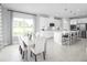 Modern kitchen with white cabinets, an island, and a dining area at 6033 Wild Petunia Dr, Wimauma, FL 33598
