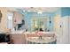 Kitchen with light cabinets, tiled floors, and breakfast bar at 6225 Emerson Dr, New Port Richey, FL 34653