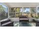 Relaxing sunroom with wicker furniture and view of backyard at 6225 Emerson Dr, New Port Richey, FL 34653