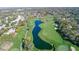 Scenic aerial view of the golf course highlighting lush greens, mature trees, and water features throughout at 6520 Pine Meadows Dr, Spring Hill, FL 34606