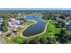 An aerial view of a golf course community with green fairways, water hazards, and beautiful landscaping at 6520 Pine Meadows Dr, Spring Hill, FL 34606