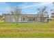A view of the screened-in pool and patio from the backyard at 6520 Pine Meadows Dr, Spring Hill, FL 34606