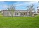 A view of the backyard featuring a screened-in pool and patio at 6520 Pine Meadows Dr, Spring Hill, FL 34606