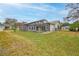 Spacious backyard featuring a large screened-in patio, offering a perfect outdoor living space at 6520 Pine Meadows Dr, Spring Hill, FL 34606