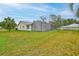 Expansive backyard featuring a screened-in lanai and lush green lawn at 6520 Pine Meadows Dr, Spring Hill, FL 34606