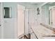 Bathroom with a shower, vanity with countertop, and white tiled walls at 6520 Pine Meadows Dr, Spring Hill, FL 34606