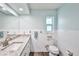 Bright bathroom showcasing a granite countertop, white cabinets, and tiled walls at 6520 Pine Meadows Dr, Spring Hill, FL 34606