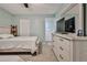 Bright bedroom with a dresser and an en-suite bathroom at 6520 Pine Meadows Dr, Spring Hill, FL 34606