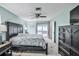 Bright bedroom with a large bed, dresser and sliding doors leading to the pool area at 6520 Pine Meadows Dr, Spring Hill, FL 34606