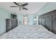 Relaxing bedroom with a ceiling fan and TV, complemented by light blue walls at 6520 Pine Meadows Dr, Spring Hill, FL 34606