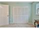 Bedroom features a large closet with bi-fold doors and fresh neutral paint at 6520 Pine Meadows Dr, Spring Hill, FL 34606