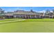 Spacious clubhouse overlooks the meticulously manicured green of the golf course at 6520 Pine Meadows Dr, Spring Hill, FL 34606