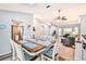 Bright dining room with table set for six with backyard view and access to the kitchen at 6520 Pine Meadows Dr, Spring Hill, FL 34606