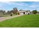 Well-maintained home with a lush green lawn, mature landscaping, and a two-car garage at 6520 Pine Meadows Dr, Spring Hill, FL 34606