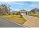 Well-maintained home with a yard that needs some TLC, mature landscaping, and a two-car garage at 6520 Pine Meadows Dr, Spring Hill, FL 34606