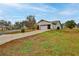 Home with a yard that needs some TLC, mature landscaping, and a two-car garage at 6520 Pine Meadows Dr, Spring Hill, FL 34606