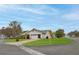 Well-maintained home on a corner lot with a lush green lawn and a convenient two-car garage at 6520 Pine Meadows Dr, Spring Hill, FL 34606