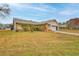 Single-story home with a green lawn, attached garage, and front yard landscaping at 6520 Pine Meadows Dr, Spring Hill, FL 34606
