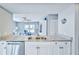 Granite countertops and stainless steel dishwasher overlook the living area at 6520 Pine Meadows Dr, Spring Hill, FL 34606