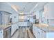 Bright kitchen featuring granite countertops, stainless steel appliances, and white cabinets at 6520 Pine Meadows Dr, Spring Hill, FL 34606