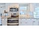Close up of kitchen with stainless steel appliances, granite countertops, and white subway tile backsplash at 6520 Pine Meadows Dr, Spring Hill, FL 34606